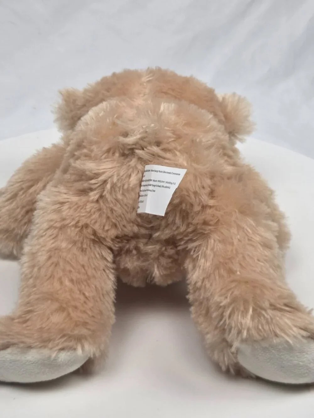 light brown plush teddy bear featuring a brown satin bow 9